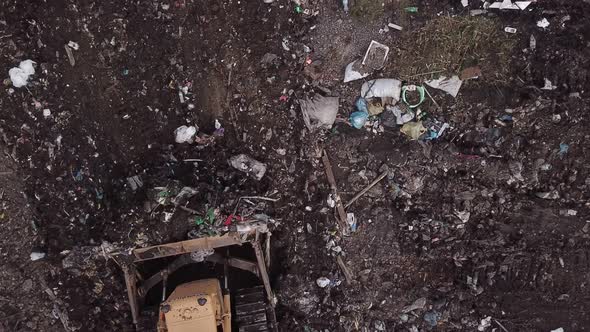 Bulldozer Collects Garbage Into a Pile