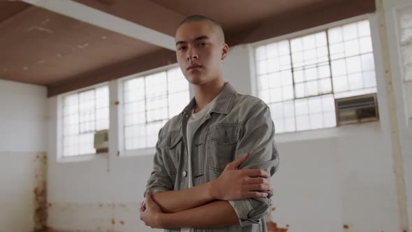 Fashionable young man in an abandoned warehouse