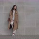 A Girl Fashionably Dressed Stands Leaning Her Foot Against a Concrete Wall  - VideoHive Item for Sale