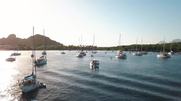 Aerial View on Lipari Islands with Green Trees and Buildings, Mountains and Sunrise. Moored Vessels