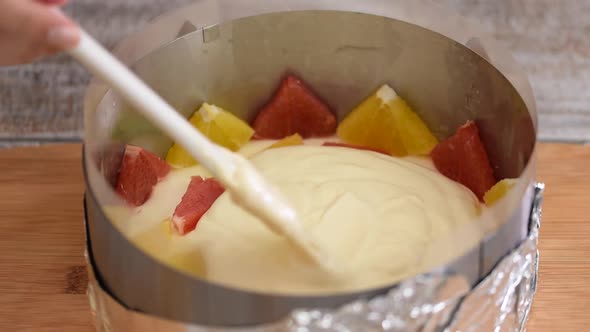 Girl Making Fruit Mousse Cake in the Kitchen