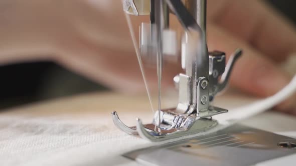 Woman Sews on a Sewing Machine Closeup of a Moving Needle Closeup