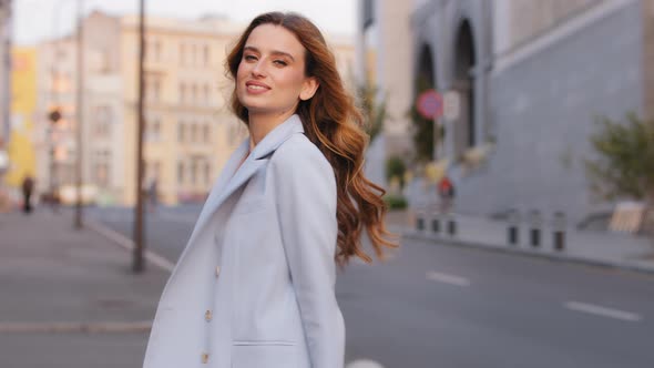 Young Stylish Beautiful Attractive Business Woman in Trendy Blue Suit Posing in City Looking at