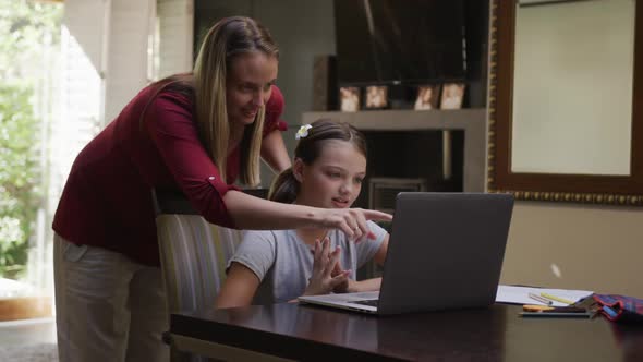 Mother and daughter looking at the laptop