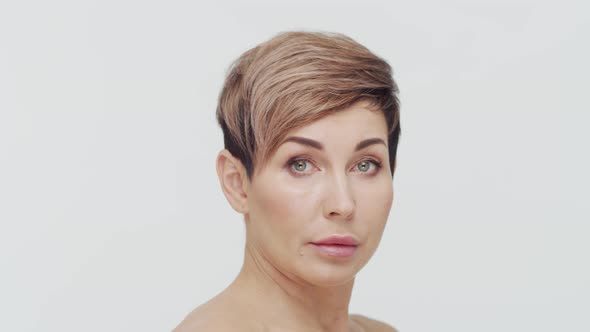 Close-up of middle aged mature woman over white background.