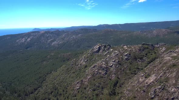 Aerial View Of Rocky Mountain Hillside In Esteiro, Spain. Dolly Back Establishing Shot