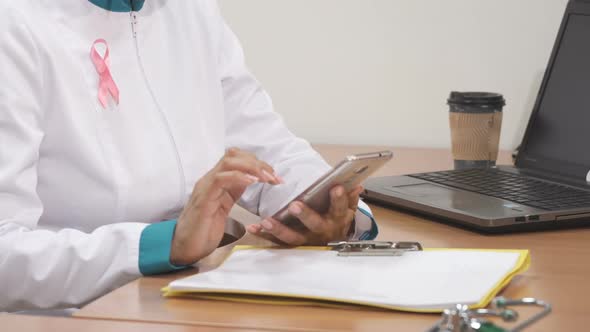 Cropped Shot of a Female Therapist Using Smart Phone at Work