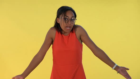 African Young Woman Saying "I Don't Know" and Spreading Her Hands To the Sides.