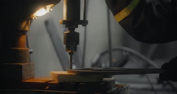 Drilling the Metal Detail on a Vertical Drilling Machine at Workshop Metalwork in Blacksmith's