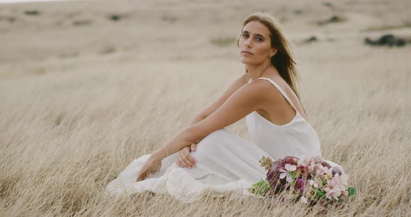 Beautiful woman relaxing in golden fields