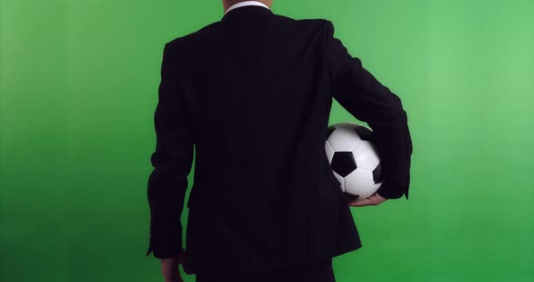 Back of Football Manager Holding Soccer Ball