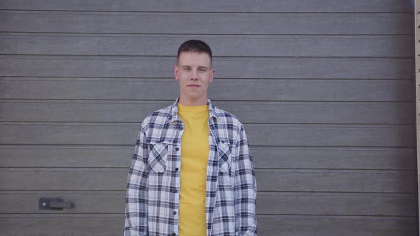 Portrait of Young Man That Looks at Camera