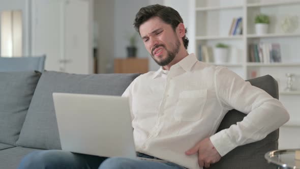 Tired Businessman Working on Laptop Having Back Pain at Home