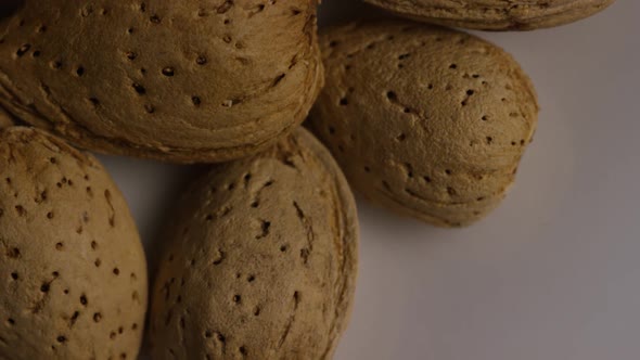 Cinematic, rotating shot of almonds on a white surface - ALMONDS