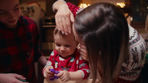 Cute Children Making Cookies with Mother on Christmas Day at Home