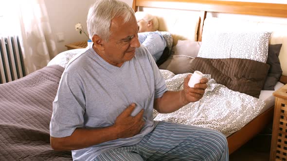 Sick senior man holding stomach