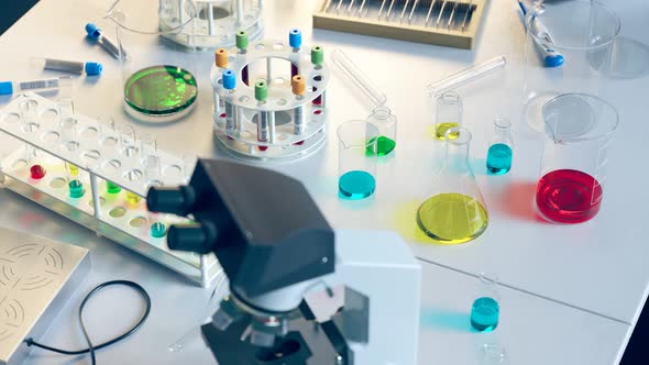 Loopable view at laboratory equipment. Beakers, flasks, tubes, microscope. 4k HD