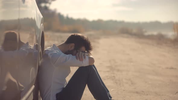 Sad Disappointed Man Sitting On Broken Car. Sad Exhausted Businessman. Problems Man On Car.