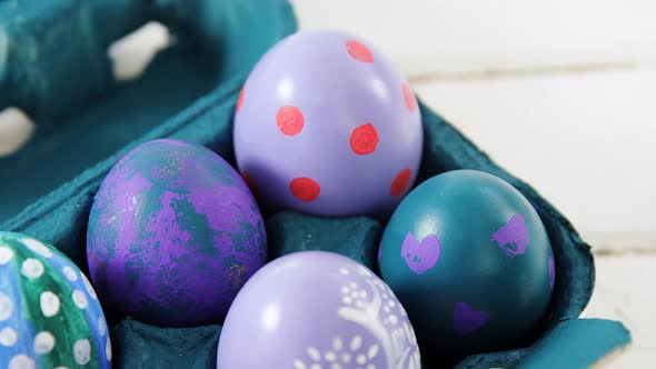 Painted Easter eggs in the carton