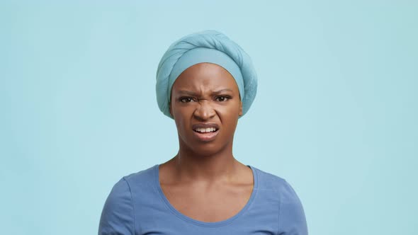 Displeased African American Woman Frowning Shaking Head Over Blue Background