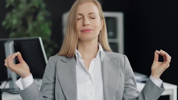 Female Entrepreneur Meditating at Office