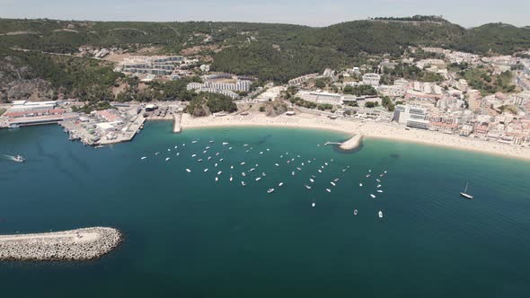 Boats moored in blue sea of Sesimbra in Portugal. Aerial drone view