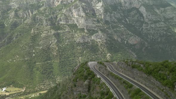 Drone Pointing at Winding Road with 180 Turn Above Canyon Valley