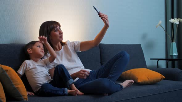 Happy Family  Mother Her Little Son Sits Couch Taking Selfie Phone