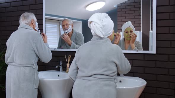 Old Senior Couple Man and Woman Doing Morning Hygiene Procedures and Looking Into a Mirror