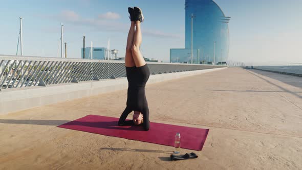 Woman Doing Salamba Sirsasana on Mat