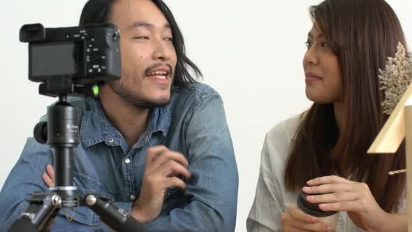 asian couple blogger or vlogger lives on social media with good story to camera home background