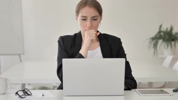 Sick Young Businesswoman Coughing at Work