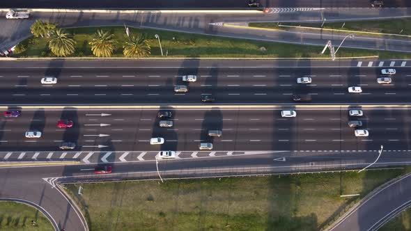 down tilt drone shot of the busy general paz highway at sunset in buenos aires in argentina