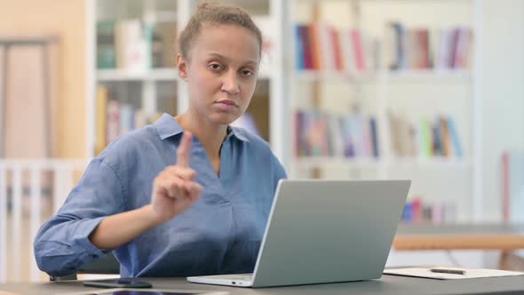 Attractive African Woman with Laptop Saying No By Finger