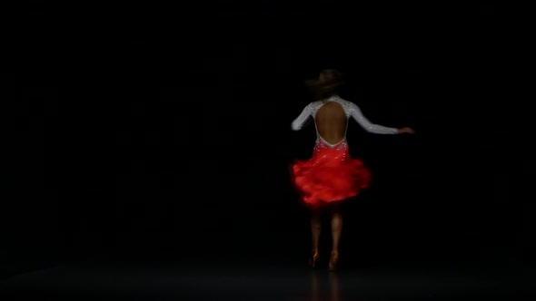 Woman Dancing Latin in a Studio on a Dark Background