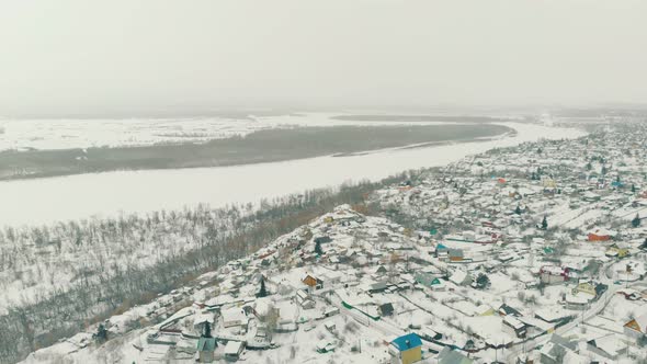 Winter Landscape with Town By Forest and River Aerial View
