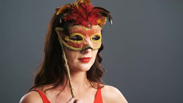 Portrait of beautiful woman wearing masquerade mask 4k