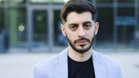 Gorgeous Bearded Handsome Business Man in Formal Wear Serious Looks at Camera Outside