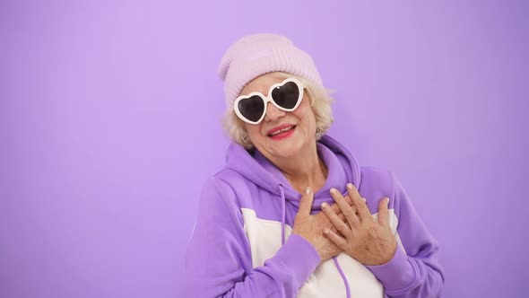 Stylish Mature Woman in Modern Glasses Sends Love To Everyone, Gesturing with Her Hands, Flirting