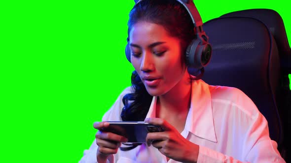 Gamer woman playing game with smartphone