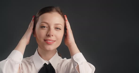 Happy Smiling Woman in Business Suit Looks to the Camera and Adjusts the Hair Office Worker Portrait