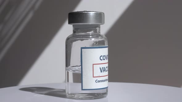 Coronavirus Covid Vaccines Rotate on a White Background in a Medical Laboratory