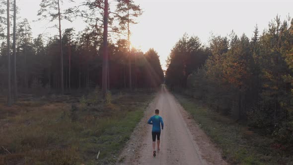 Man running along forest path