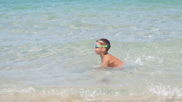 Cute Baby Boy Swimming in Sea Water on a Sunny Summer Day Slowmotion Video