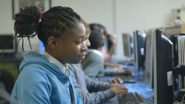 MS Schoolboys and schoolgirls using computer in computer laboratory
