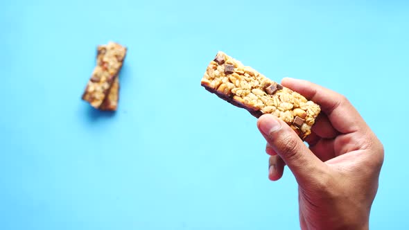 Hand Hold a Almond  Raisin and Oat Protein Bars Close Up