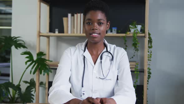 Portrait of african american female doctor having a video chat talking and smiling