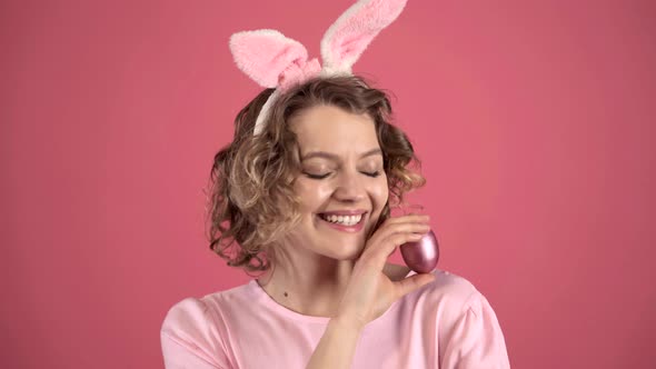 Happy Easter. Funny Young Woman with Bunny Ears, Hold Egg.