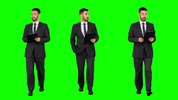 Businessman with a Tablet Walks on Green Screen. Three Takes.