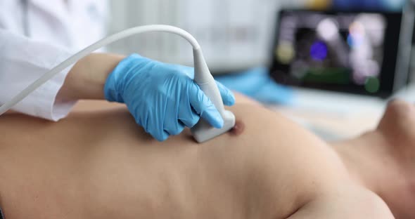 Doctor Uses Ultrasound Machine to Scan Heart of Male Patient